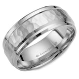 A white gold wedding band with a hammered center and beveled edges.