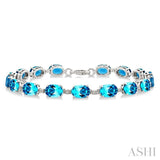 7X5 MM Oval Shape Blue Topaz and 1/10 Ctw Single Cut Diamond Semi-Precious Bracelet in Sterling Silver