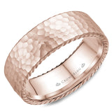A wedding band in rose gold with a hammered finish and rope detailing.