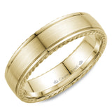 A wedding band in yellow gold with a brushed center and rope detailing.