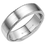 A wedding band in white gold with rope detailing on the edges.