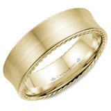 A wedding band in yellow gold with a brushed finish and rope detailing. 