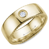 A wedding band in yellow gold with rope detaining on the sides and a round diamond.