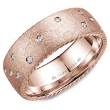A wedding band in rose gold with 21 diamonds and rope detailing on the sides. 
