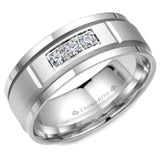 A white gold wedding band with a sandblast center and three diamonds in a prong setting.
