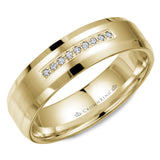 A wedding band in yellow gold with a brushed center, featuring nine diamonds and beveled edges. 