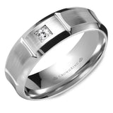 A white gold wedding band with a round diamond and line detailing.