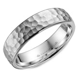 A hammered white gold wedding band with polished edges.