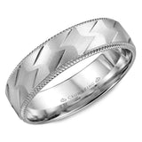 A white gold wedding band with a patterned center and milgrain detailing.