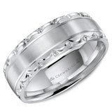 A wedding band with a brushed center, line detailing and textured edges.
