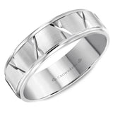 A white gold wedding band with a brushed center and intricate line detailing.