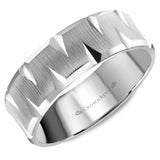 A wedding band in white gold with a textured center and carved detailing.