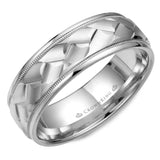 A white gold wedding band with a carved patterned center and milgrain detailing. 