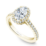 A Noam Carver yellow gold engagement ring with an oval cut center diamond, a halo and 54 diamonds.