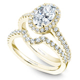 A Noam Carver yellow gold engagement ring with an oval cut center diamond, a halo and 54 diamonds.