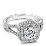 A Noam Carver white gold engagement ring with a round cut diamond in a double cushion halo, a split band and 80 diamonds.