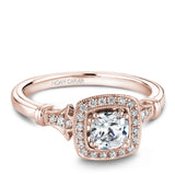 A Noam Carver rose gold engagement ring with a cushion cut center stone, a halo and 26 diamonds.