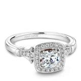 A Noam Carver white gold engagement ring with a cushion cut center stone, a halo and 26 diamonds.