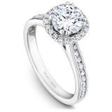 A Noam Carver white gold engagement ring with a round halo, 42 diamonds and milgrain detailing on a band.