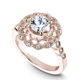 A Noam Carver rose gold engagement ring with a floral halo and 18 round diamonds.