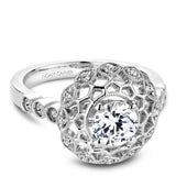 A Noam Carver white gold engagement ring with a floral halo and 18 round diamonds.