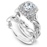 A Noam Carver white gold engagement ring with a cushion halo, 24 round diamonds and a detailed floral band. 