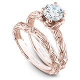 A Noam Carver rose gold engagement ring with a round centerpiece, 2 diamonds on a setting and a floral band.