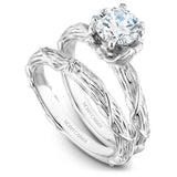 A Noam Carver white gold engagement ring with a round centerpiece, 2 diamonds on a setting and a floral band.