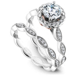 A Noam Carver white gold engagement ring with rose gold accents, a round centerpiece and 34 diamonds on a floral band.
