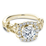 A Noam Carver yellow gold engagement ring with a cushion halo, 18 round diamonds and a detailed floral band. 
