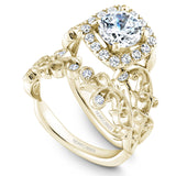 A Noam Carver yellow gold engagement ring with a cushion halo, 18 round diamonds and a detailed floral band. 