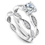A Noam Carver white gold engagement ring with a round centerpiece and 30 diamonds on a floral band.