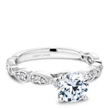 A Noam Carver white gold engagement ring with a round centerpiece and a floral band dazzled with 18 diamonds.