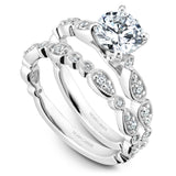 A Noam Carver white gold engagement ring with a round centerpiece and a floral band dazzled with 18 diamonds.