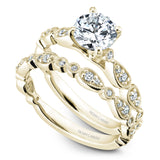A Noam Carver yellow gold engagement ring with a round centerpiece and a floral band dazzled with 18 diamonds.