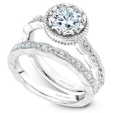 A Noam Carver white gold engagement ring with a floral setting, a detailed band and 32 round diamonds.