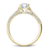 A Noam Carver yellow gold engagement ring with an oval centerpiece and 66 diamonds.