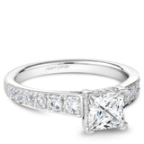 A Noam Carver white gold engagement ring with a princess cut centerpiece and 24 diamonds.