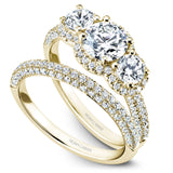A Noam Carver yellow gold engagement ring with 100 diamonds.