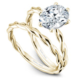 A Noam Carver yellow gold engagement ring with a twist band and an oval center diamond.