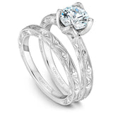 A Noam Carver engraved white gold engagement ring with a round center diamond.