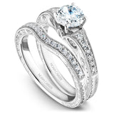 A Noam Carver engraved white gold engagement ring with 18 round diamonds on a band. 