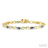 4x3 MM Oval Cut Sapphire and 1/10 Ctw Single Cut Diamond Bracelet in 14K Yellow Gold