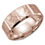 A rose gold wedding band with a hammered finish and notch detailing.