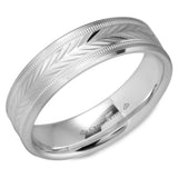 A white gold wedding band with a carved patterned center and milgrain detailing.