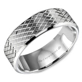 A wedding band in white gold with a carved line pattern.