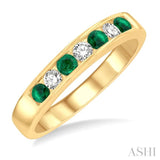 1/5 Ctw Channel Set Round Cut Diamond and 2.5 MM Round Cut Emerald Band in 14K Yellow Gold