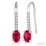 1/20 Ctw Round Cut Diamond and Oval Cut 5x3mm Ruby Precious Earrings in 10K White Gold